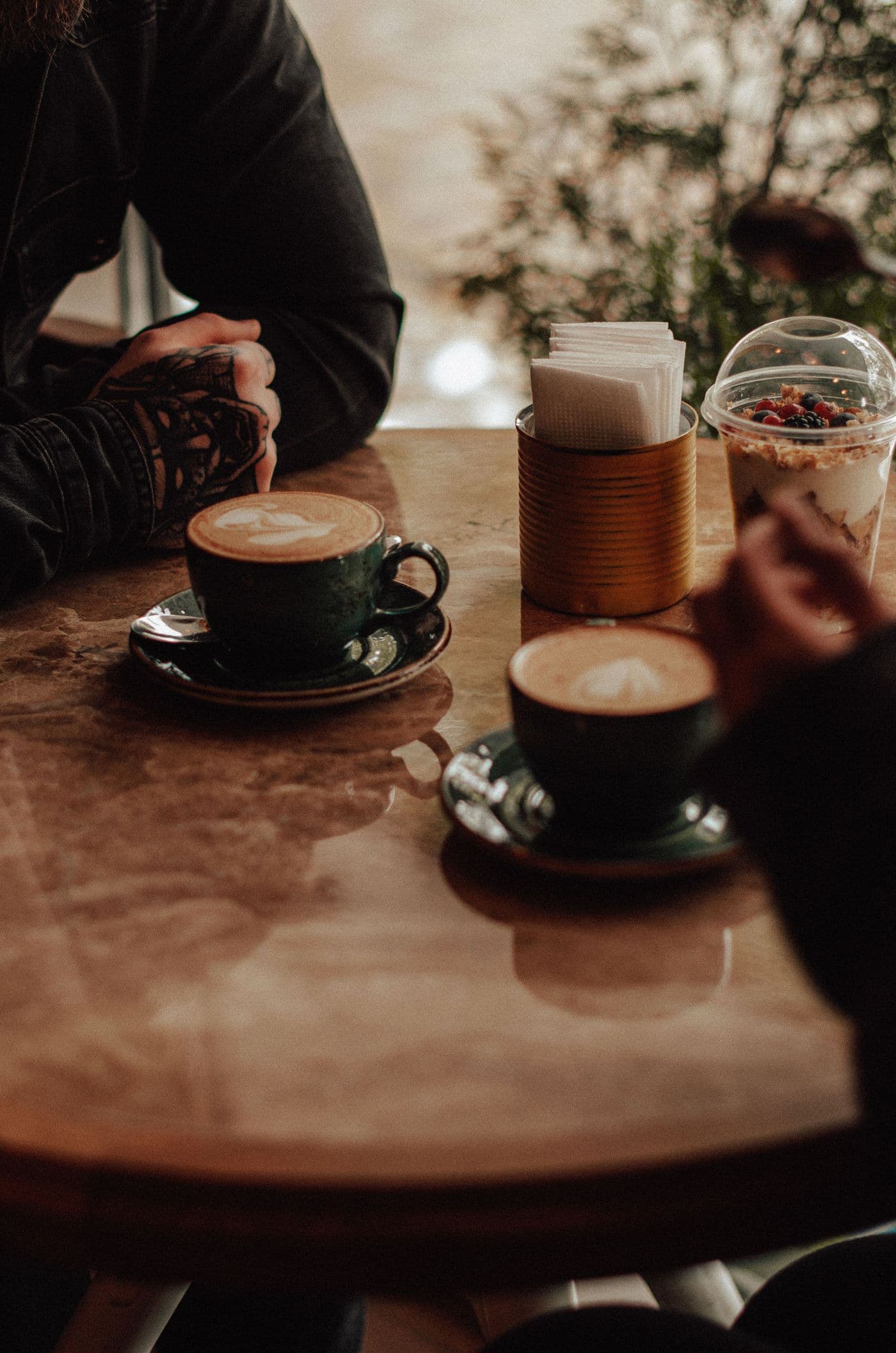 Due persone sedute a un tavolino con due tazze di caffè